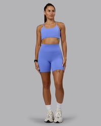 Woman wearing Twist Sports Bra - Indulgent Blue