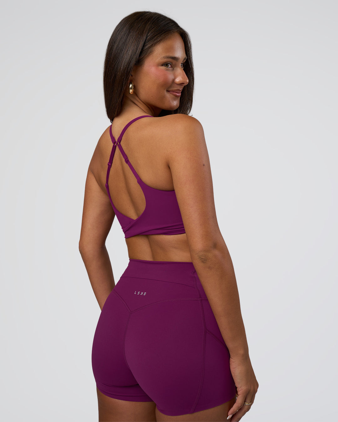 Woman wearing Twist Sports Bra - Plum Caspia | Model:Bianca | Size:S