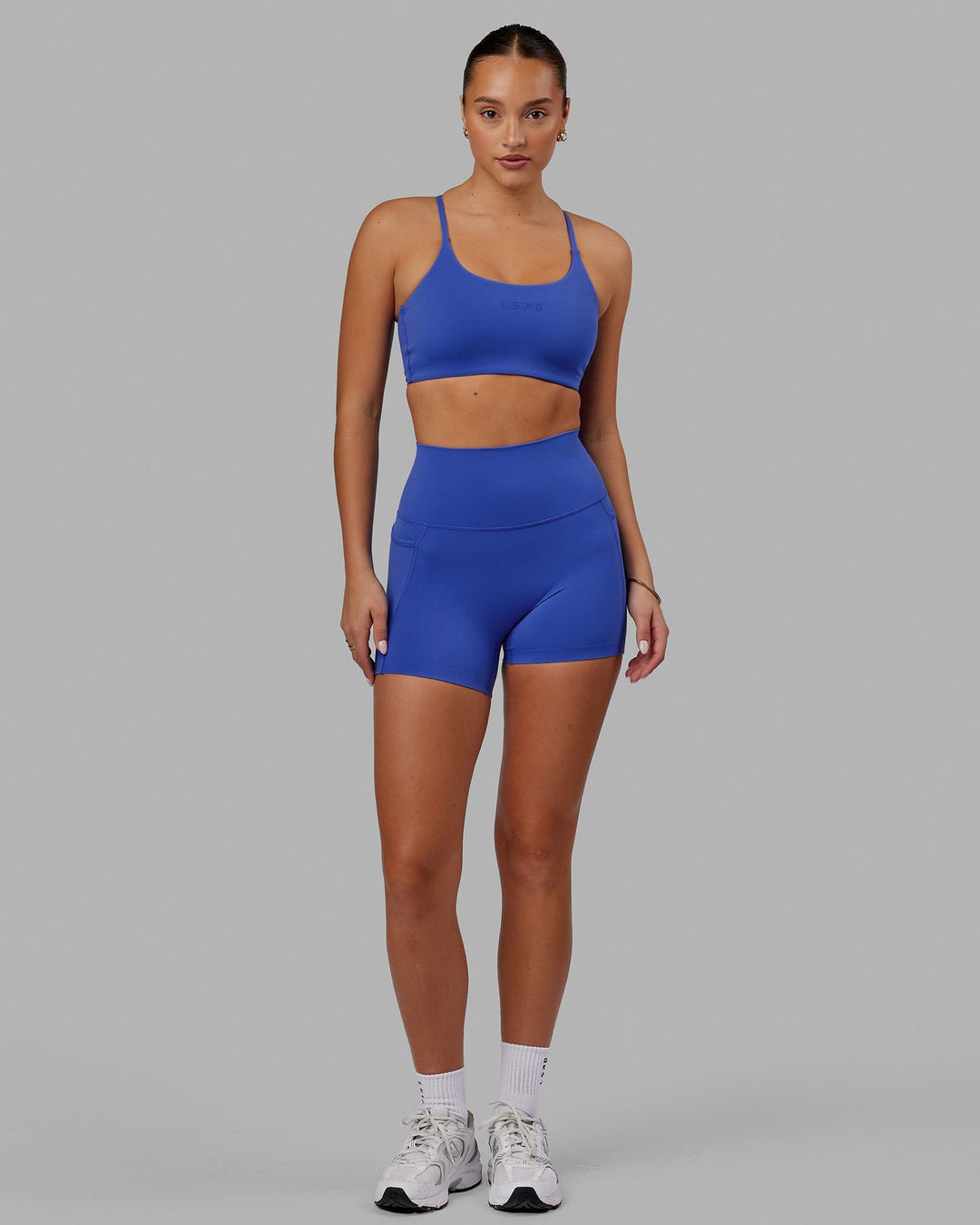 Woman wearing Twist Sports Bra - Power Cobalt