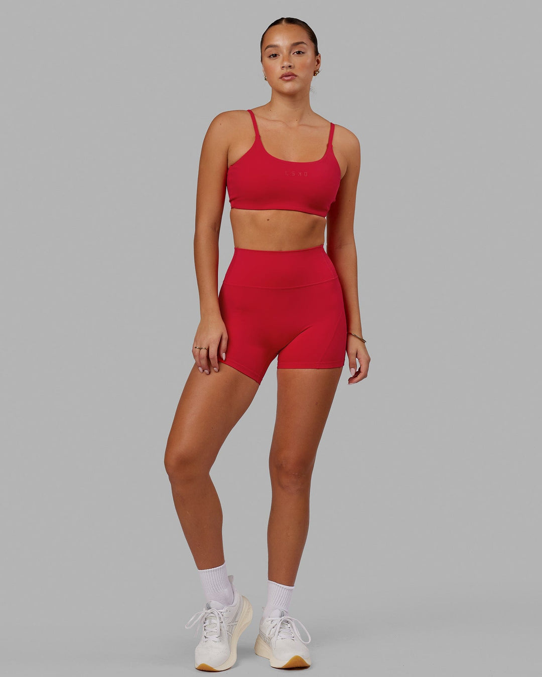 Woman wearing Twist Sports Bra - Scarlet