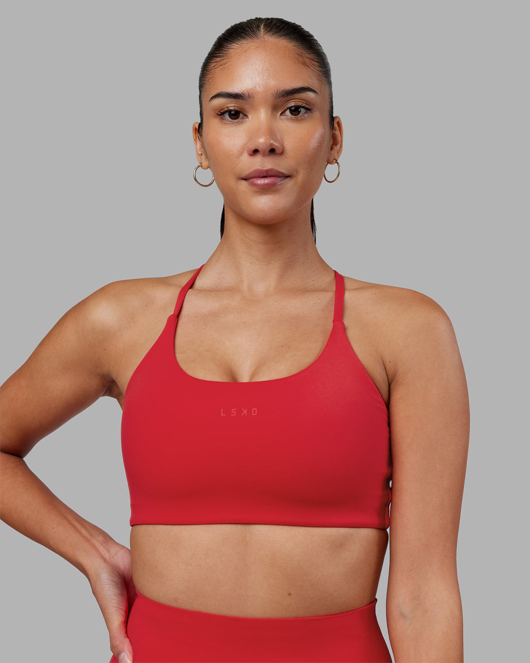Woman wearing Twist Sports Bra - Scarlet | Model:Rhiley | Size:S