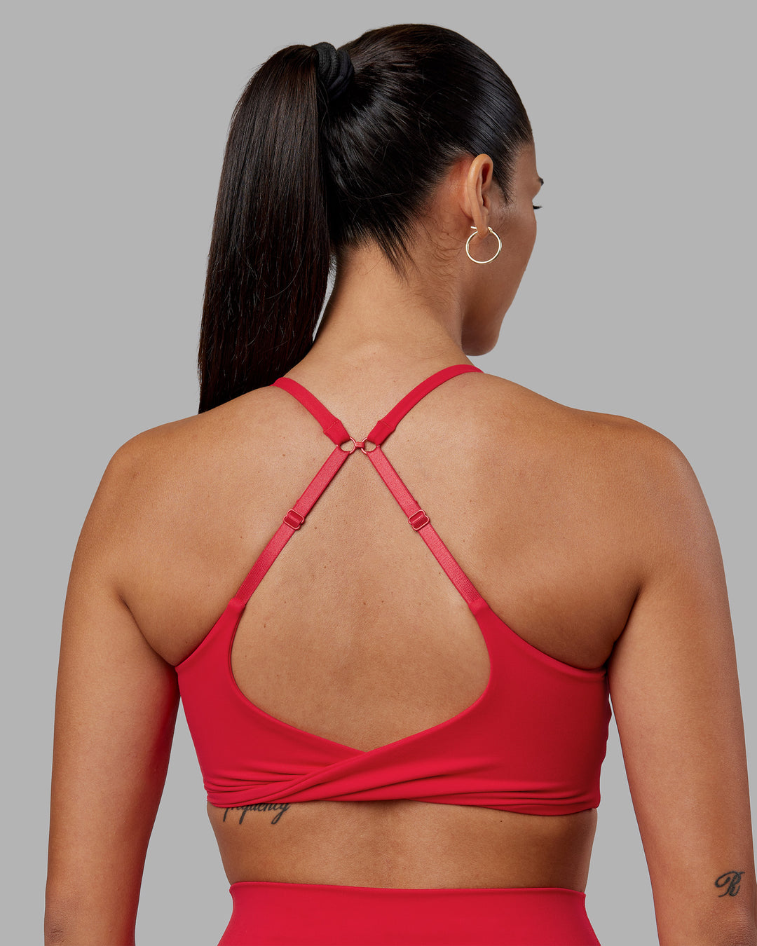 Woman wearing Twist Sports Bra - Scarlet | Model:Rhiley | Size:S