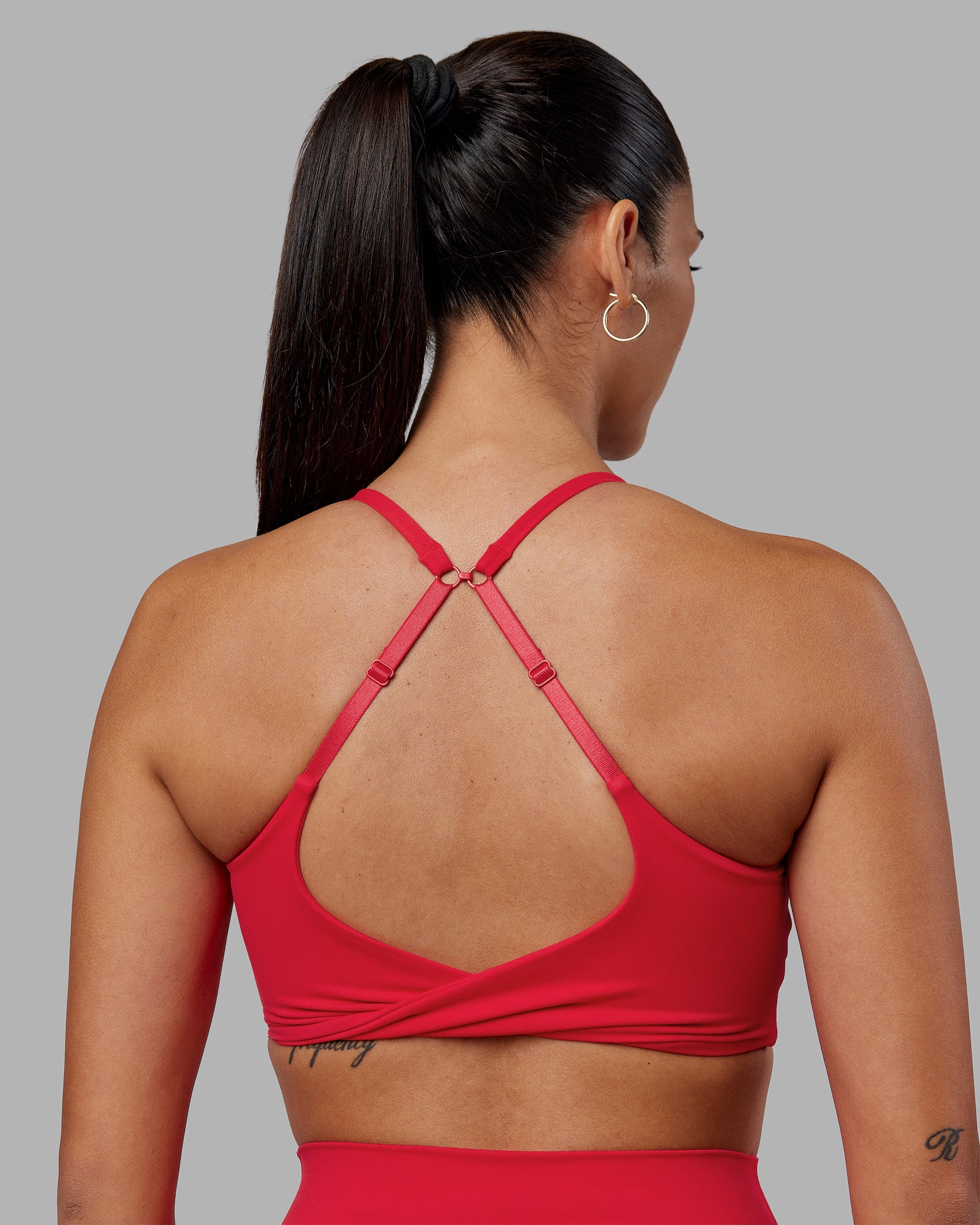 Woman wearing Twist Sports Bra - Scarlet | Model:Rhiley | Size:S