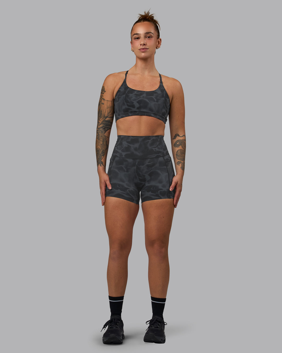 Woman wearing Twist Sports Bra - Tranquil-Black