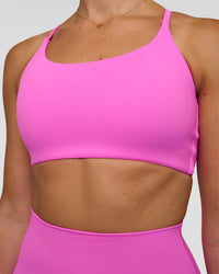 Woman wearing Twist Sports Bra - Ultra Fuchsia | Model:Myrte | Size:S