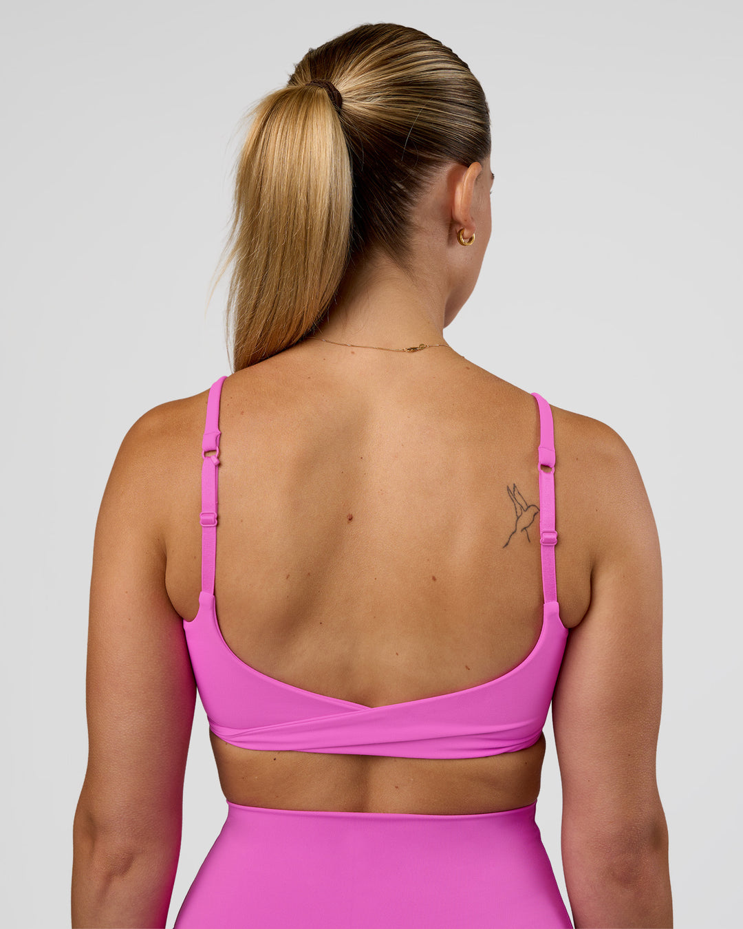 Woman wearing Twist Sports Bra - Ultra Fuchsia | Model:Myrte | Size:S