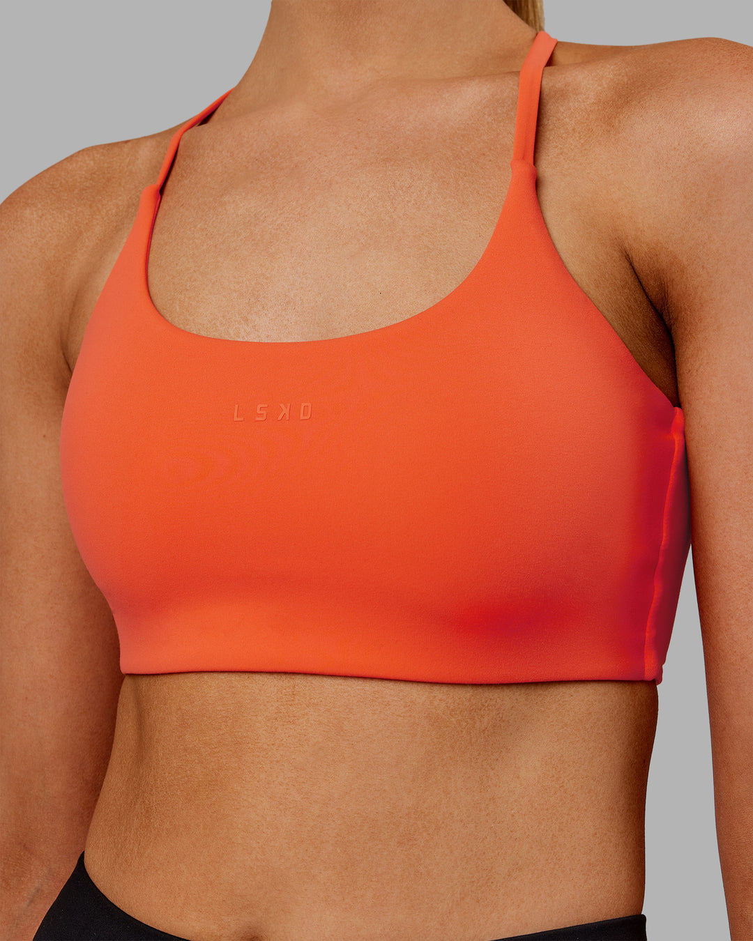 Woman wearing Twist Sports Bra - Ultra Orange | Model:Ella | Size:S