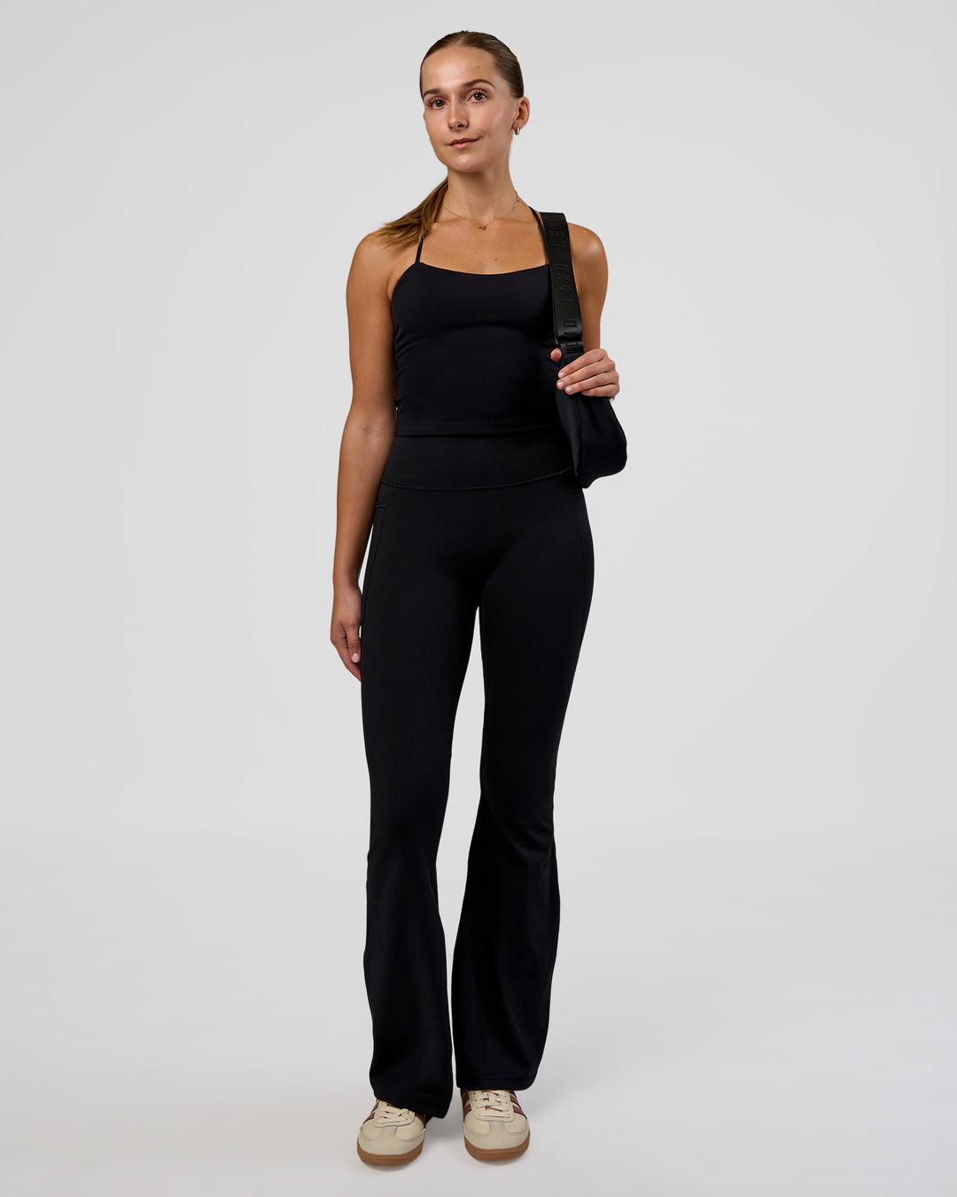 Woman wearing Twister Shelf Bra Tank - Black | Model:Myrte | Size:S