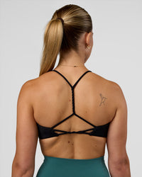 Woman wearing Twister Sports Bra - Black  | Model:Myrte | Size:S