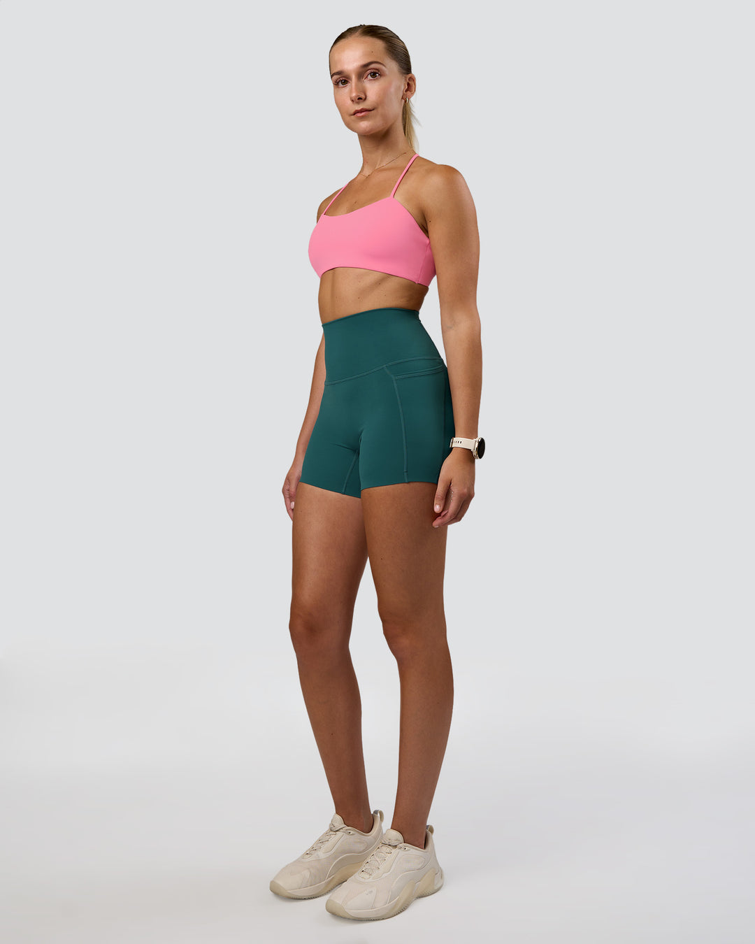 Woman wearing Twister Sports Bra - Candy Pink | Model:Myrte | Size:S