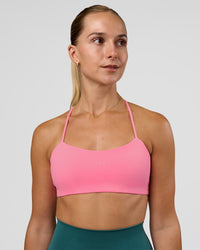 Woman wearing Twister Sports Bra - Candy Pink | Model:Myrte | Size:S