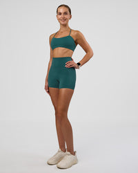 Woman wearing Twister Sports Bra - Transformative Teal | Model:Myrte | Size:S
