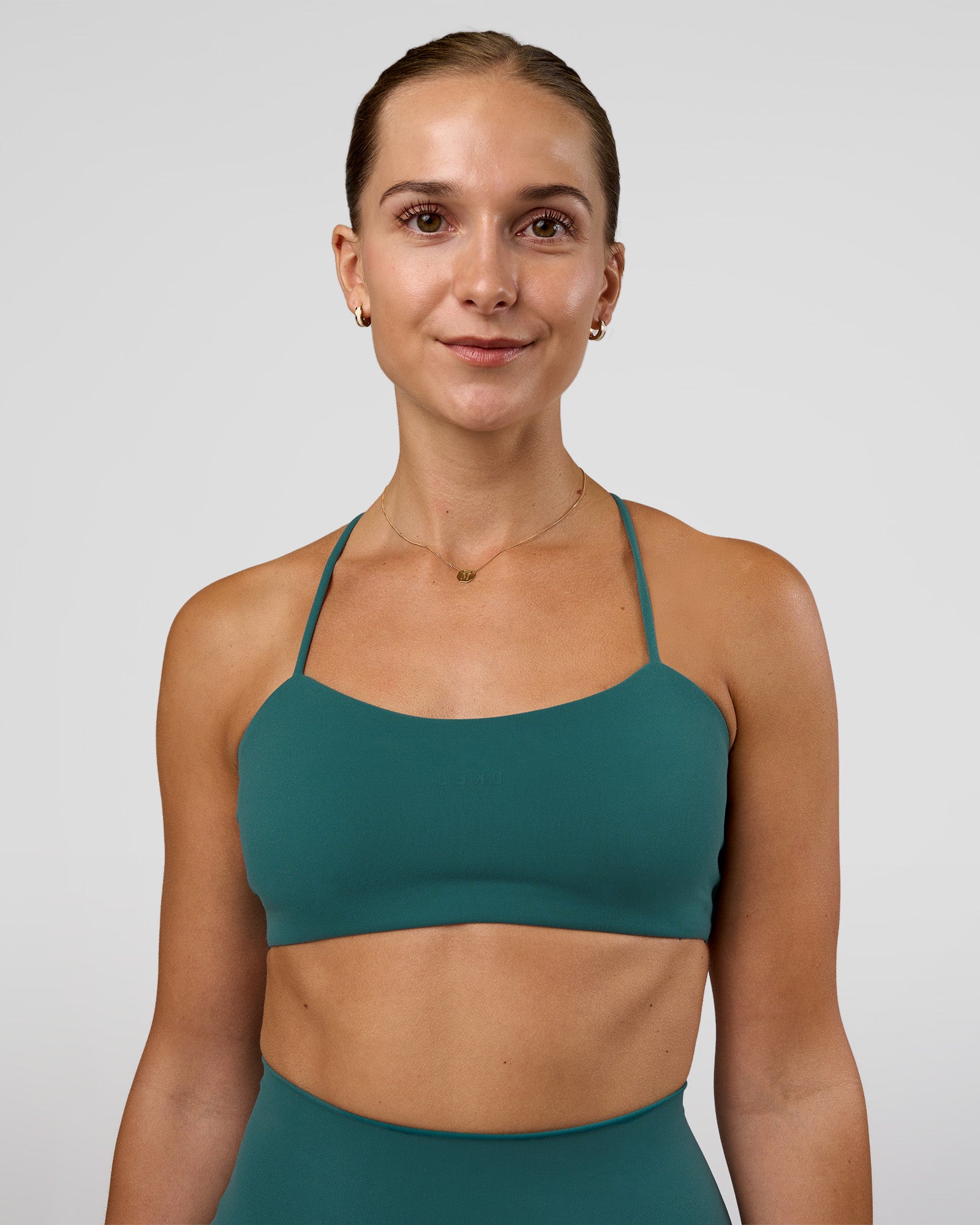 Woman wearing Twister Sports Bra - Transformative Teal | Model:Myrte | Size:S