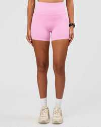 Woman wearing Unbreakable Ultra High-Rise 4" Short - Pink Rose-White | Model:Rhiley | Size:S