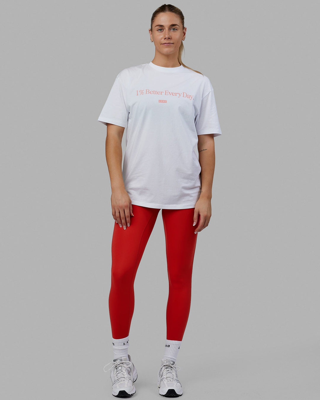 Woman wearing Unisex 1% Better FLXCotton Tee Oversize - White-Coral