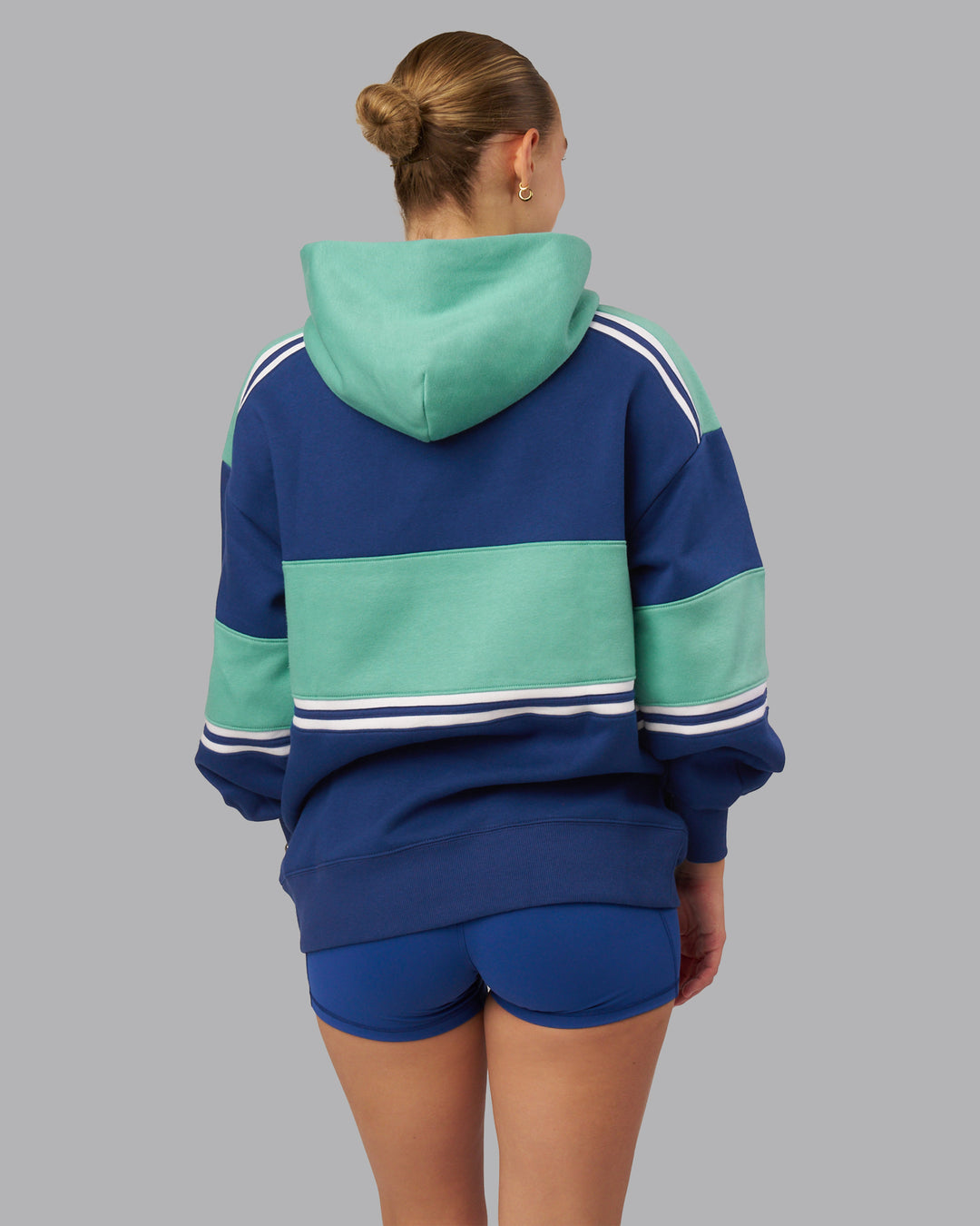 Woman wearing A-Team Oversized Hoodie - Midnight Blue-Agate Green | Model:Lillie| Size:S