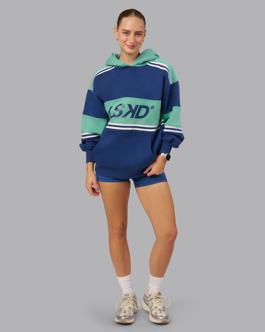 Woman wearing A-Team Oversized Hoodie - Midnight Blue-Agate Green | Model:Lillie| Size:S