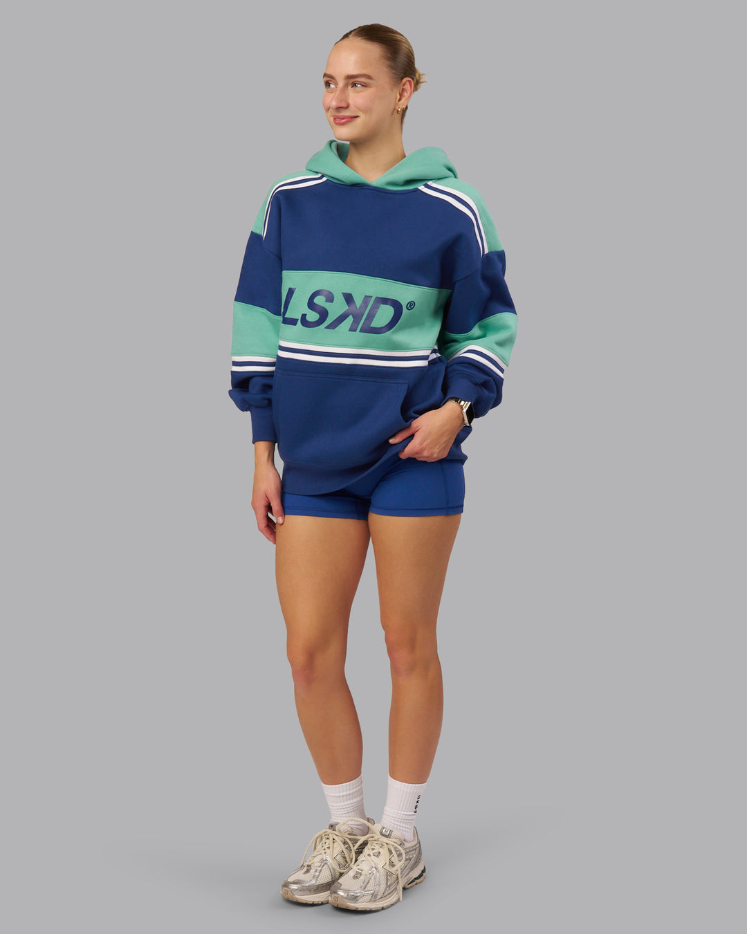 Woman wearing A-Team Oversized Hoodie - Midnight Blue-Agate Green | Model:Lillie| Size:S