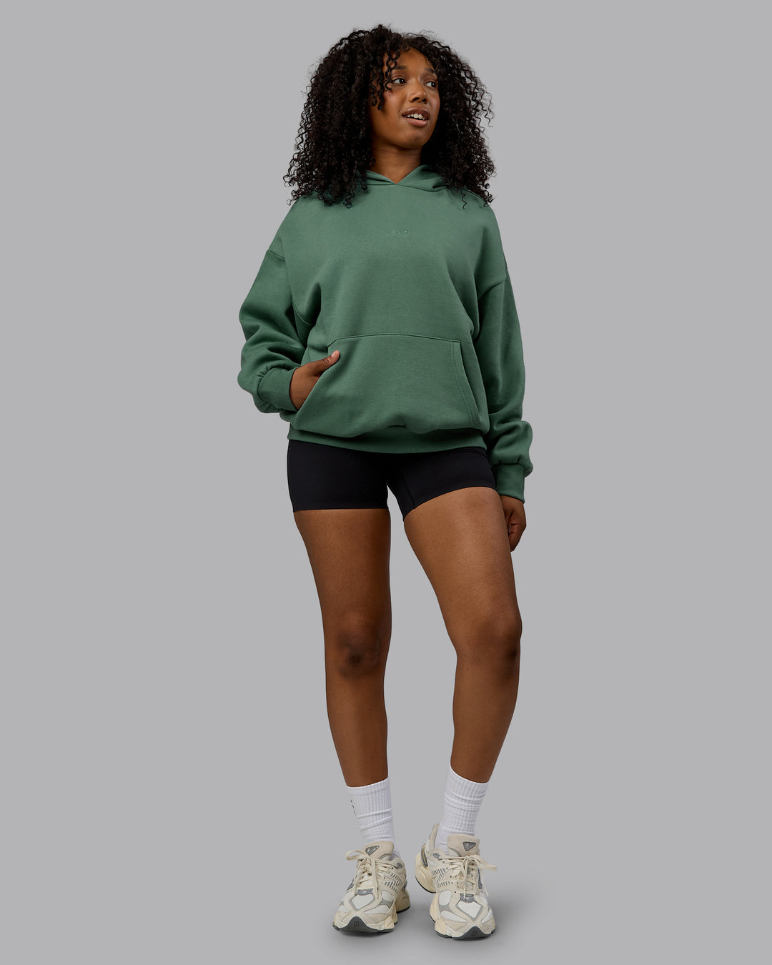 Woman wearing Unisex MVP Hoodie Oversize - Sage Brush