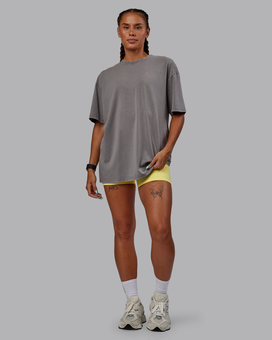 Woman wearing Unisex Miami25 Washed FLXCotton Tee Oversize - Storm Front-Lemon Fizz
