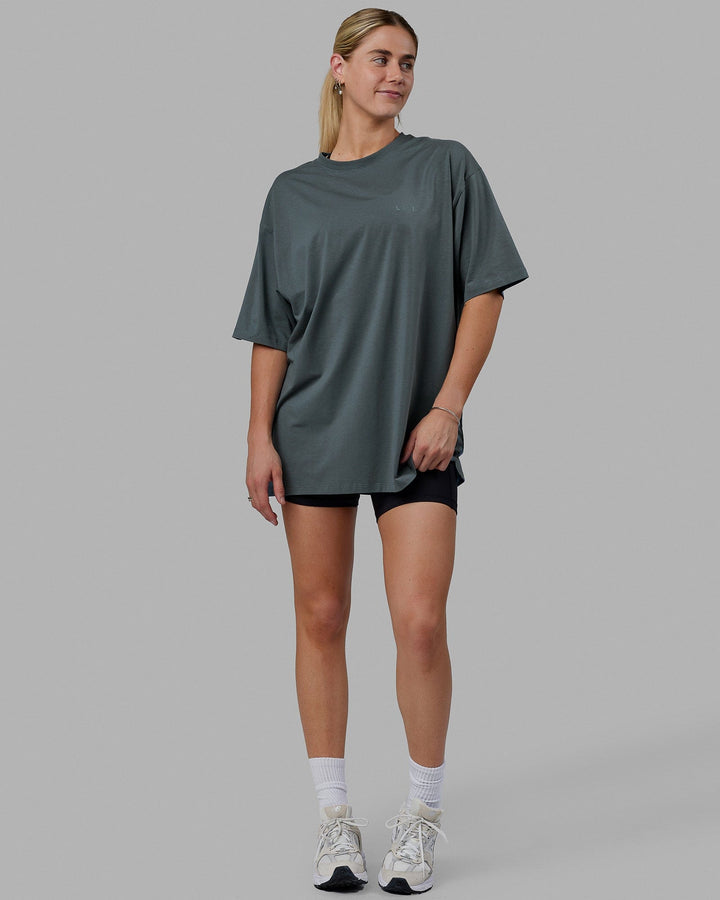 Woman wearing Unisex PimaFLX Tee Oversize - Storm