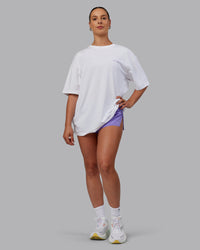 Woman wearing Unisex Strike Through FLXCotton Tee Oversize - White-Purple Swirl