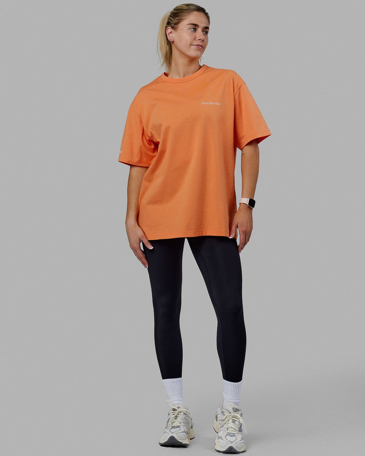 Woman wearing Unisex Taylor Tee Oversize - Tangerine