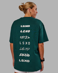 Woman wearing Variation FLXCotton Oversized Tee in Dark Moss-Digital Mist | Size:S