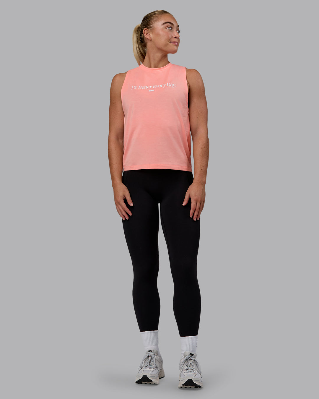 Woman wearing Unleash 1% Better Training Tank - Murex Shell-White