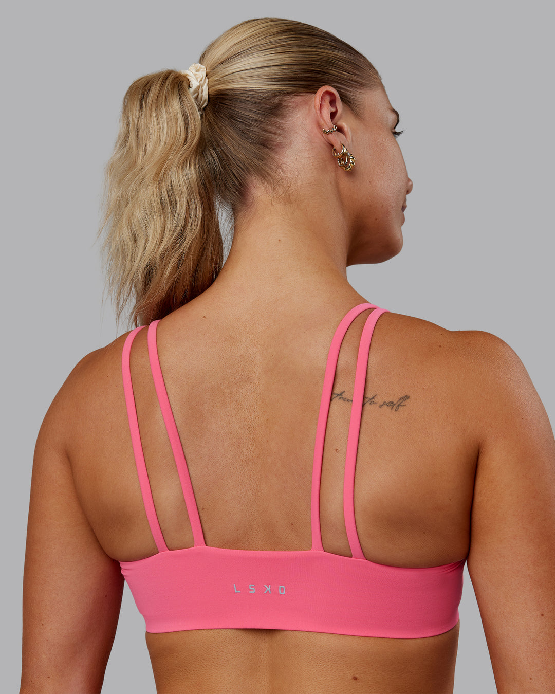 Woman wearing Vantage Sports Bra in Pink Lemonade | Size:S