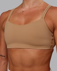 Woman wearing Vantage Sports Bra in Warm Smoke | Size:S