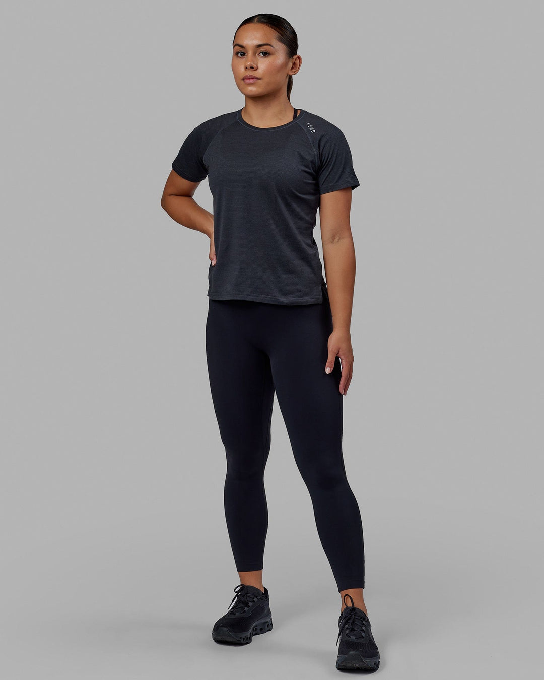 Woman wearing Perform VapourFLX Tee - Black Marl