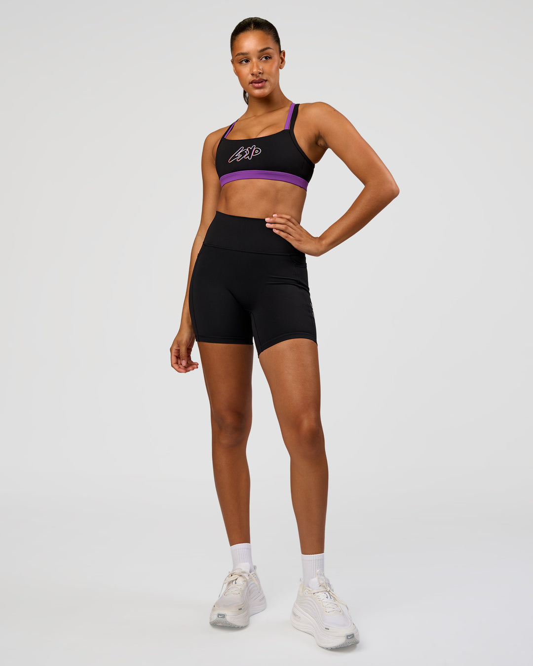 Woman wearing Velocity Graphic Sports Bra - Black-Radiate | Model:Rosie | Size:S