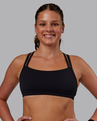 Woman wearing Velocity Sports Bra - Black | Model:Phoebe | Size:S