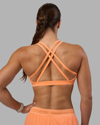Woman wearing Velocity Sports Bra - Cantaloupe | Model:Hannah | Size:S