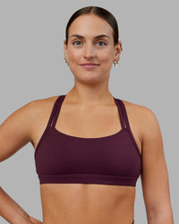 Woman wearing Velocity Sports Bra - Cherry Lacquer | Model:Keisha | Size:S