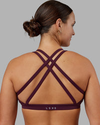 Woman wearing Velocity Sports Bra - Cherry Lacquer | Model:Keisha | Size:S