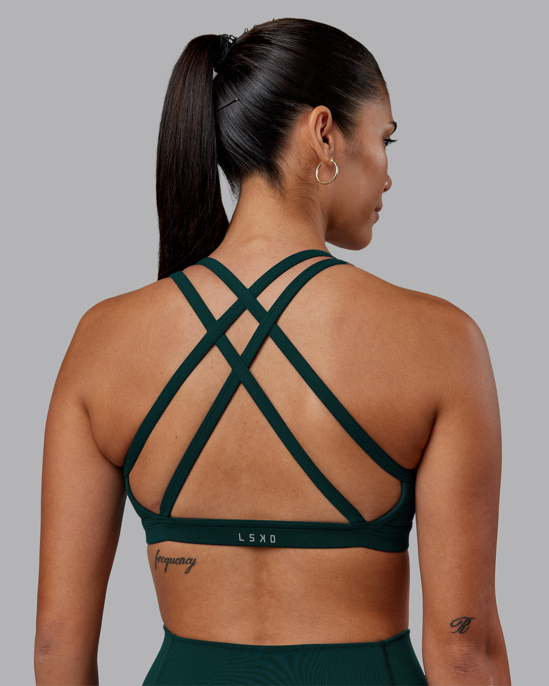 Woman wearing Velocity Sports Bra - Dark Moss | Model:Rhiley | Size:S