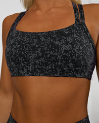 Woman wearing Velocity Sports Bra - Energy Print Black | Model:Amity | Size:S