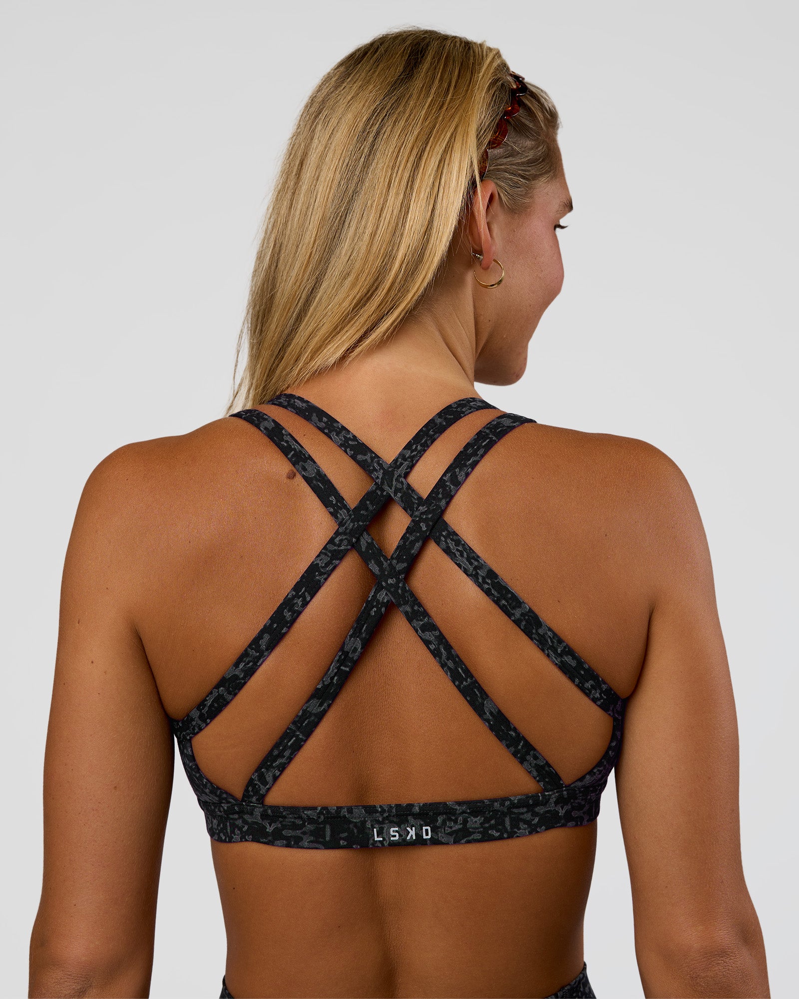 Woman wearing Velocity Sports Bra - Energy Print Black | Model:Amity | Size:S