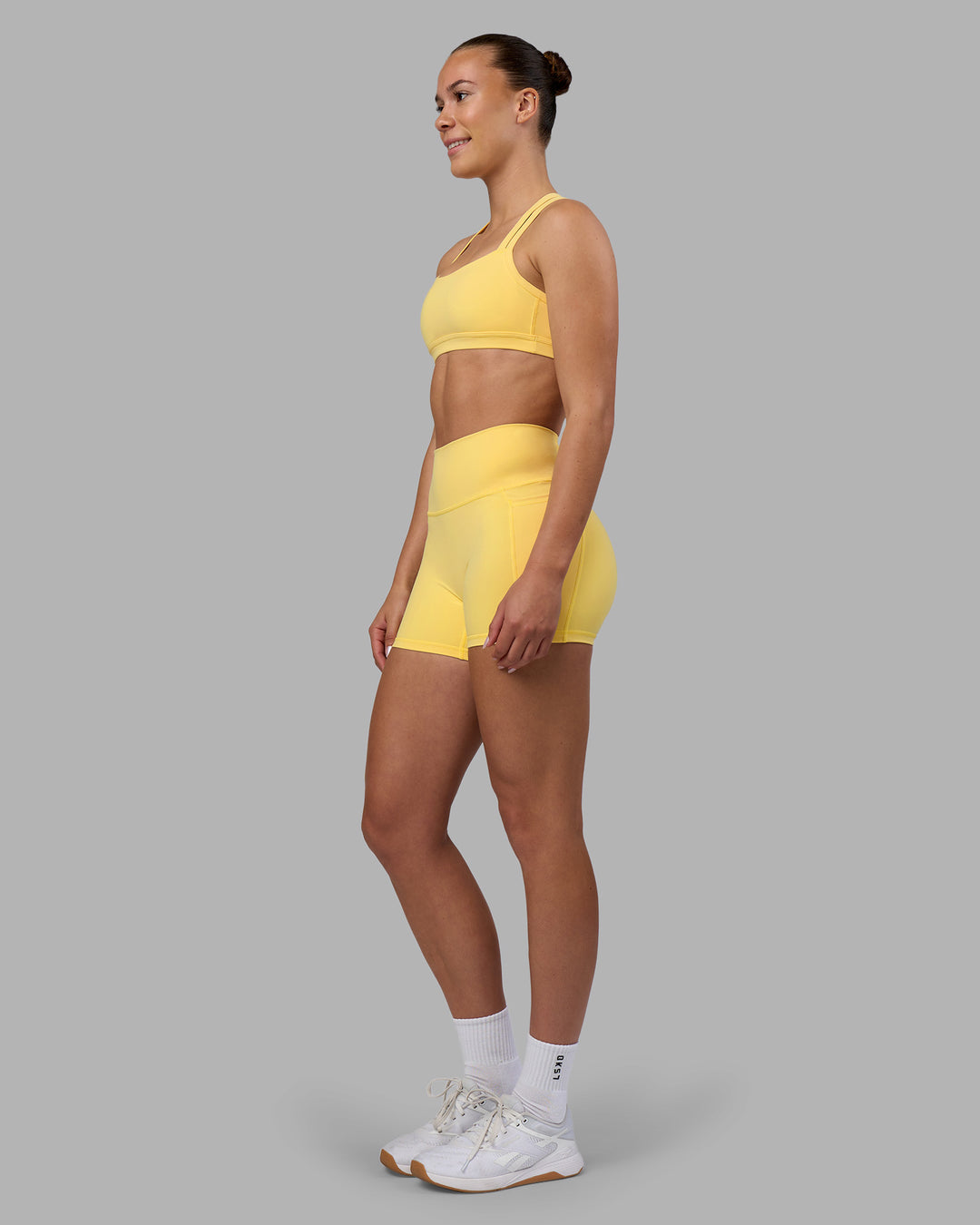 Woman wearing Velocity Sports Bra - Lemon | Model:Charlize | Size:S