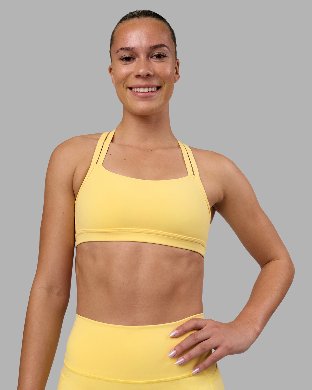 Woman wearing Velocity Sports Bra - Lemon | Model:Charlize | Size:S