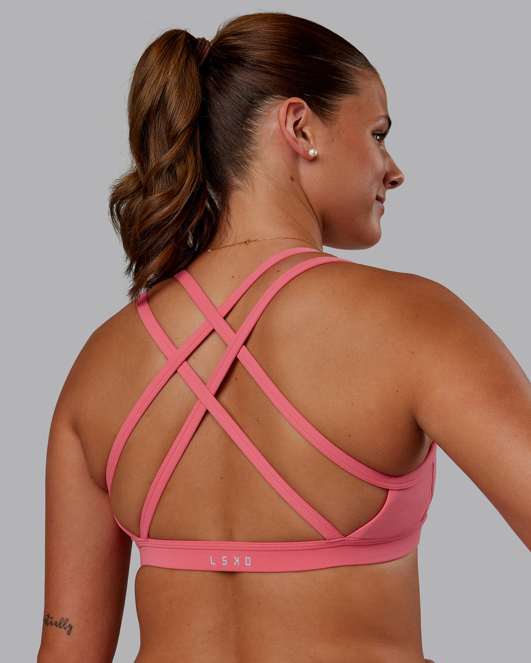 Woman wearing Velocity Sports Bra -- Pink Lemonade | Model:Phoebe | Size:S