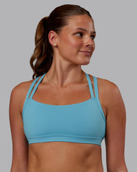 Woman wearing Velocity Sports Bra - Retro Blue | Model:Phoebe | Size:S