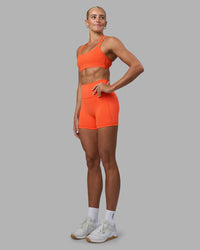 Woman wearing Velocity Sports Bra - Ultra Orange | Model:Katie | Size:S