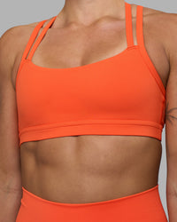 Woman wearing Velocity Sports Bra - Ultra Orange | Model:Katie | Size:S