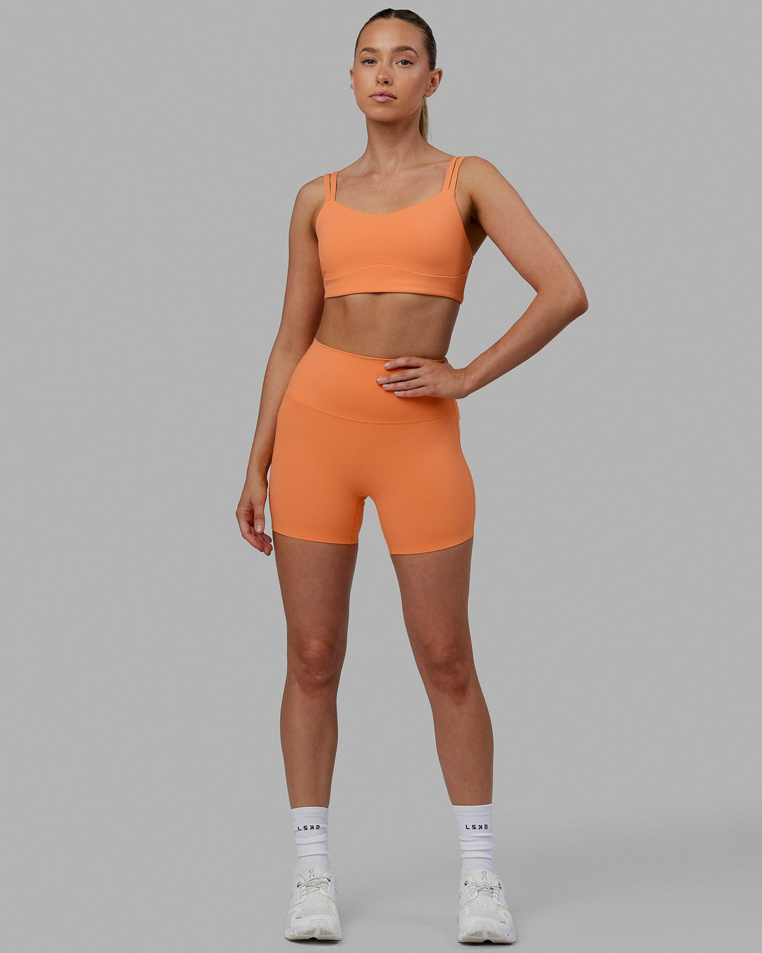 Woman wearing Vogue Sports Bra - Tangerine