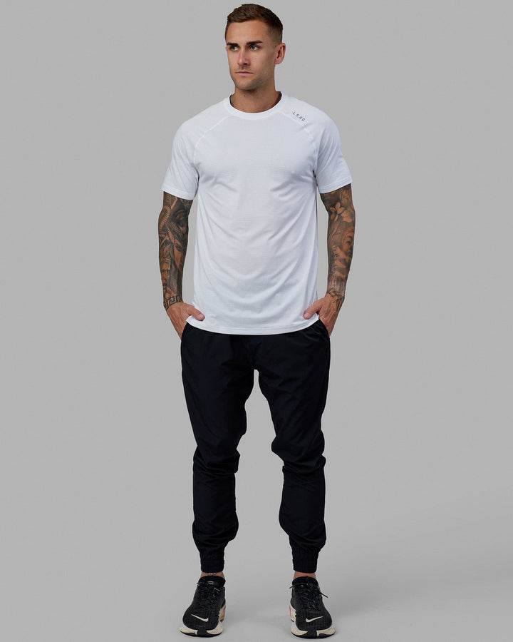 Man wearing Warm Up Zip Cuff Performance Pant - Black