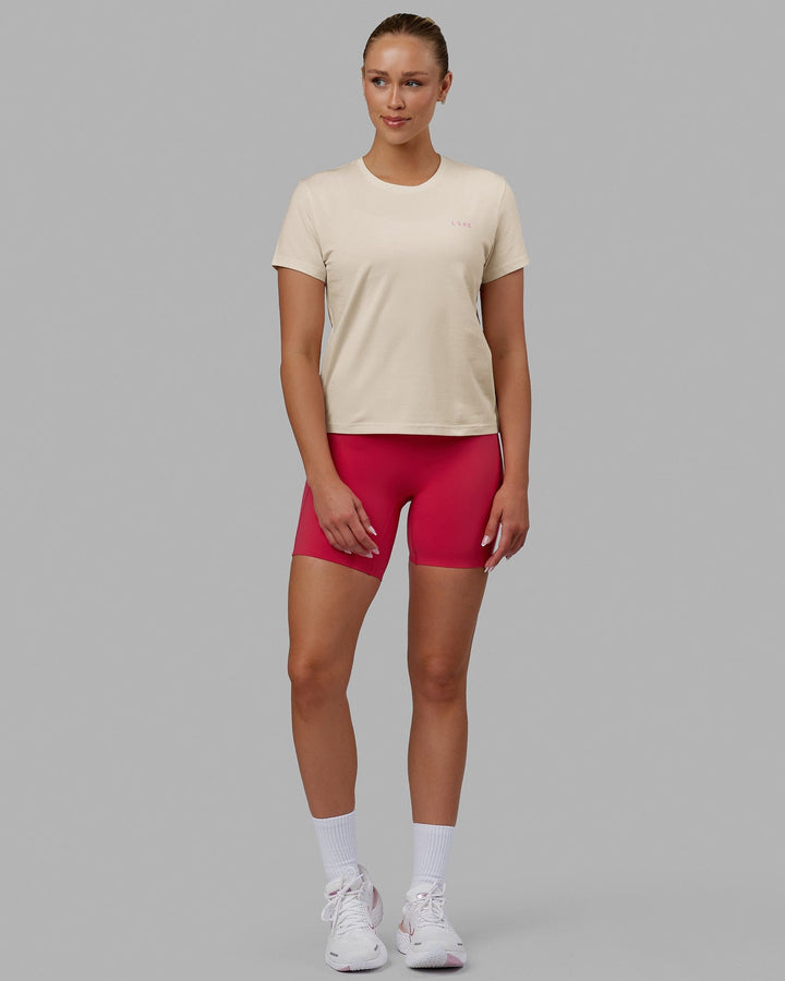 Woman wearing We Rise FLXCotton Tee - Cream