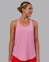 Woman wearing AeroFLX+ Drop Armhole Seamless Tank - Candy Pink | Model:Paris | Size:S
